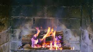 Fire In Brick Fireplace In Old Cabin