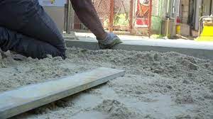 Worker Level The Sand For Paving Slabs