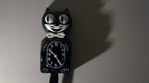 A Kit Cat Clock In Dramatic Lighting