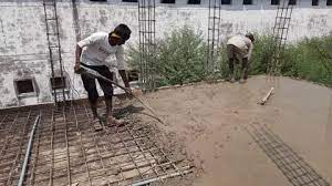 Construction Worker Leveling A Poured