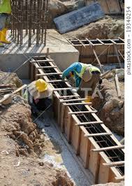 workers fabricating ground beam