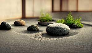 A Zen Garden With Stones And Grass On