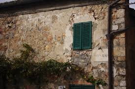 Green Shutter On Building Tuscany Italy