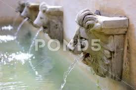 Water Flow From Lion Statue On Wall