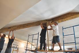 hand hewn beams on a finished ceiling