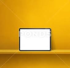 Digital Tablet Pc On Yellow Wall Shelf