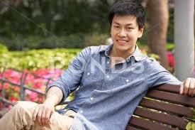 Young Chinese Man Relaxing On Park