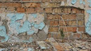 Brick Wall With Crumbling Plaster On