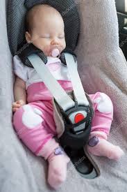 Newborn Baby Girl Sitting In A Car Seat