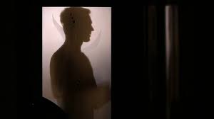Silhouette Of A Man Behind A Glass Door