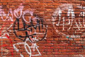 Red Brick Wall With Graffiti In