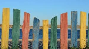 Multi Colored Fence On The Beach
