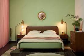A Bedroom With Light Green Walls And