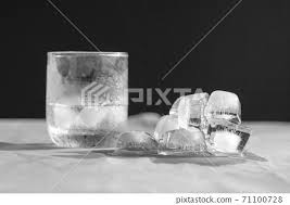 Half Glass Of Water With Ice Cubes And
