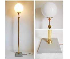A Vintage Brass Floor Lamp With A Large