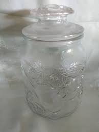 A Glass Apothecary Jar And Lid With A