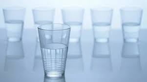 Pitcher Is Filling Up Four Glasses With