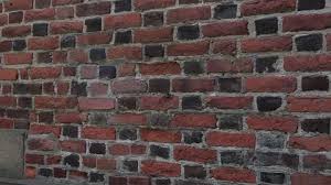 An Old Brick Wall Made Of Red Bricks A