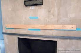 wood mantel on a masonry fireplace