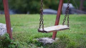 Old Wooden Swing With A Metal Chain
