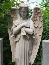 An Angel With A Dove Sculpture In The