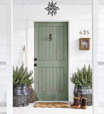 A Sage Green Door On A White Home