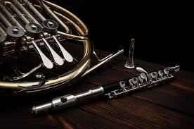 French Horn And Flute On A Wooden Table