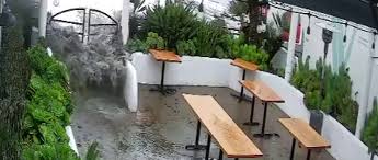 Flood Waters Rush Into Outdoor Patio Of