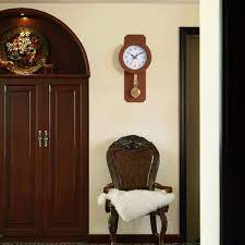 Clockswise Traditional Brown Round Wood Looking Pendulum Plastic Wall Clock For Living Room Kitchen Or Dining Room