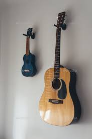 Guitar And An Ukulele Hanging