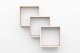 Empty Wooden Shelves On White Wall With