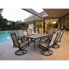 Hanover Venice 7 Piece Dining Set With 6 Sling Swivel Rocker Chairs And 66 In X 40 In Slat Top Table