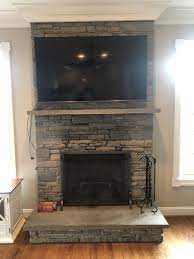 75 Tv Mounted Above Stone Fireplace