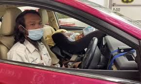 Taxi Driver In Bangkok Drives With Baby