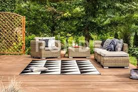 Geometrical Rug And Rattan Furniture