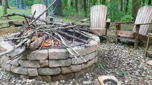 Feeding Fire In Stone Fire Pit With