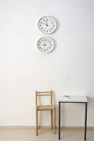 Clocks Near Table With Chair In Room