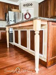 A Kitchen Island With Trim And Legs