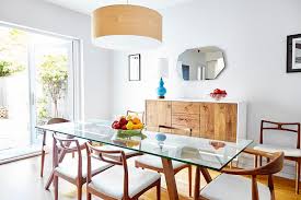 Available in different natural finishes, this table will be able to match different color schemes. Inviting Dining Room Features Danish Modern Furniture And Bright Natural Light Hgtv