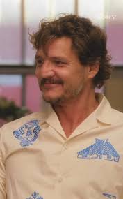 Pedro Pascal rocks a retro beige blazer and rust shirt, marking a stylish  shift from his earlier casual dark sweaters and clean-shaven face.