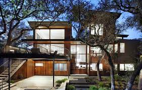 We build modern homes using old ways of construction and build solid stone mass walls out of texas limestone. Wood And Limestone House Built Among Trees
