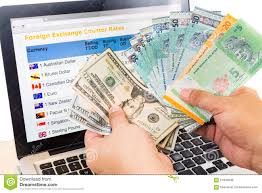 Hand Sorting Usd And Ringgit In Front Of Currency Exchange