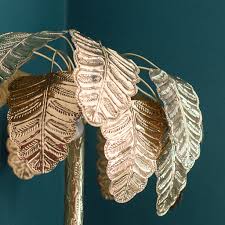 This decorative table lamp features a cylindrical shape with intricately carved palm fronds layered all over for a pop of texture and lively style. Brass Palm Tree Floor Lamp Gold Audenza