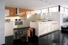 The blue and black kitchen scores high marks for its inviting, stylish appearance. Kitchen Of The Day Bright Design By Alno W Cream Cabinets Black Wood Floors Orange Walls Clerest Kitchen Design Modern Kitchen Design White Modern Kitchen