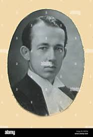 This portrait features William Dickson MacDonald, born in 1913, capturing  his professional demeanor in a formal setting. The photograph reflects his  role in his field and offers a glimpse into his career