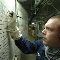 amage Controlman 3rd Class Jeffrey Garvin, from Grand Rapids, Mich., takes  up slack