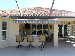 Awning Over The Bar At This Sarasota Home Will Keep Guests Cool While Enjoying A Relaxing Afternoon Retractable Awning Awning Hurricane Shutters