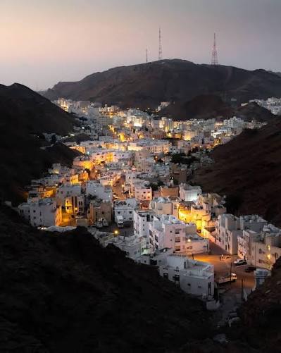 Traditional white buildings and mountains near Muscat, Oman