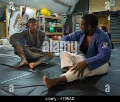 U.S. Army Sgt. Kristopher Miles, Camp Lemonnier Military Police Base Access  Control Office noncommissioned officer in charge, learns Brazilian  Jiu-Jitsu techniques from U.S. Air Force Senior Master Sgt. Chris Easter,  Combined Joint