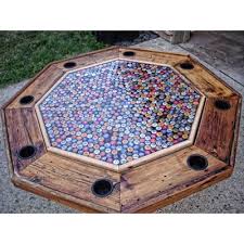 Bottle cap mosaic on an electrician's spool table. Beer Can Art Recycling Beer Cans